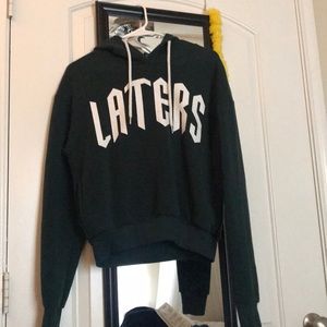 A dark green crop top hoodie